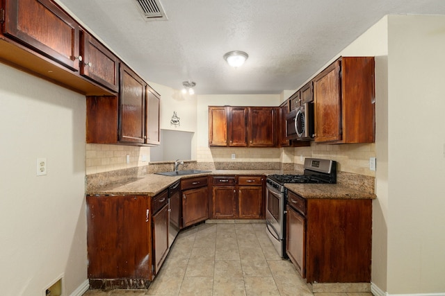 2351 Loyanne Dr, Spring, TX 77373 - kitchen featuring stainless steel appliances, tasteful backsplash, and dark stone countertops