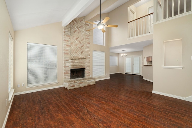 2351 Loyanne Dr, Spring, TX 77373 - unfurnished living room featuring a ceiling fan, a fireplace, dark wood-style floors, a chandelier, and high vaulted ceiling