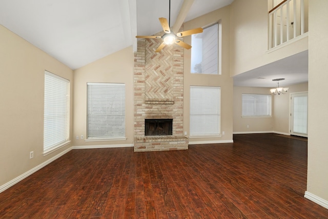 2351 Loyanne Dr, Spring, TX 77373 - unfurnished living room with high vaulted ceiling, a ceiling fan, a fireplace, wood finished floors, and a chandelier