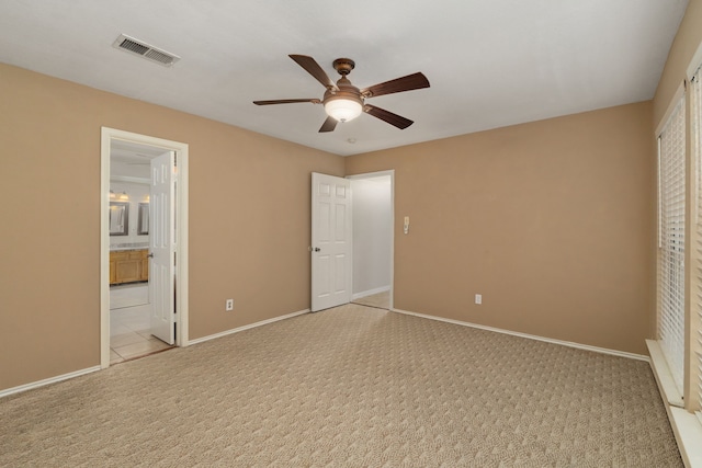 2351 Loyanne Dr, Spring, TX 77373 - unfurnished bedroom featuring light colored carpet, connected bathroom, and ceiling fan