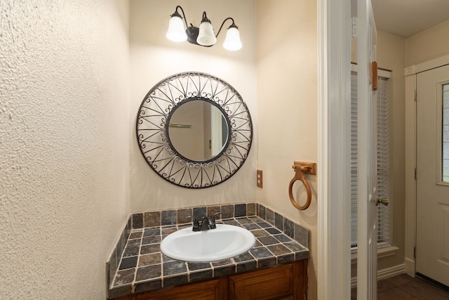 2351 Loyanne Dr, Spring, TX 77373 - bathroom featuring vanity, tile patterned flooring, and a textured wall