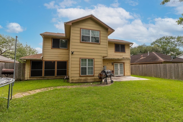 2351 Loyanne Dr, Spring, TX 77373 - rear view of house with french doors, a fenced backyard, a patio, a trampoline, and roof with shingles