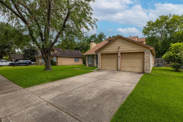 2351 Loyanne Dr, Spring, TX 77373 - view of front of house featuring brick siding, driveway, an attached garage, and a chimney
