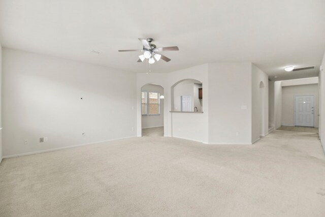 15107 Sequoia Meadow Ct, Humble, TX 77346 - unfurnished living room with light colored carpet, ceiling fan, and arched walkways