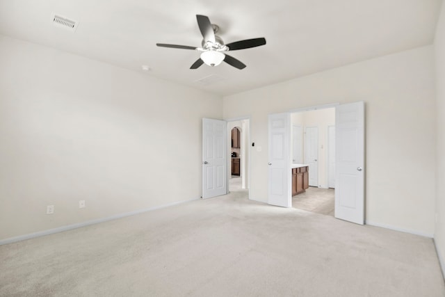 15107 Sequoia Meadow Ct, Humble, TX 77346 - unfurnished bedroom featuring light carpet, connected bathroom, and a ceiling fan