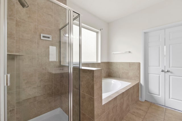 15107 Sequoia Meadow Ct, Humble, TX 77346 - bathroom with a shower stall, a garden tub, and tile patterned floors