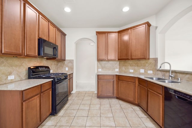 15107 Sequoia Meadow Ct, Humble, TX 77346 - kitchen with black appliances, arched walkways, decorative backsplash, light tile patterned flooring, and recessed lighting