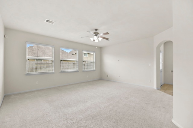 15107 Sequoia Meadow Ct, Humble, TX 77346 - spare room featuring light carpet, a ceiling fan, and arched walkways