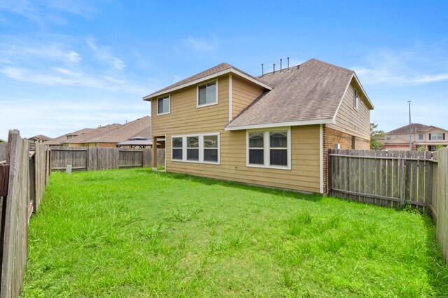 15107 Sequoia Meadow Ct, Humble, TX 77346 - back of property featuring a shingled roof, a fenced backyard, and brick siding