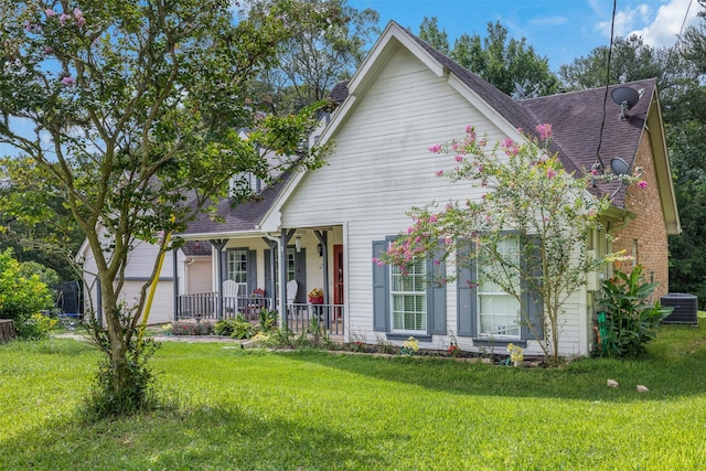 3357 Tamy Ln, Brenham, TX 77833 - view of front facade with covered porch, a front yard, and a shingled roof