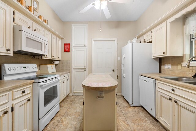 3357 Tamy Ln, Brenham, TX 77833 - kitchen featuring white appliances, a center island, tasteful backsplash, and ceiling fan