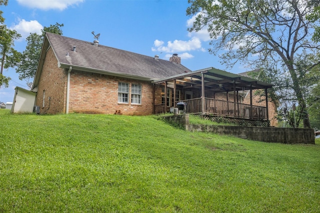 3357 Tamy Ln, Brenham, TX 77833 - rear view of property featuring brick siding, a chimney, a yard, and roof with shingles