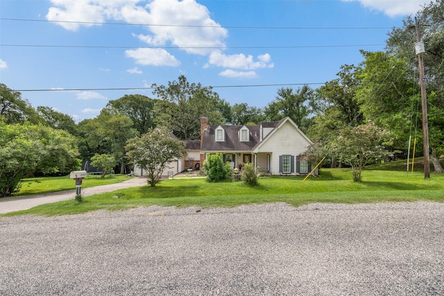 3357 Tamy Ln, Brenham, TX 77833 - cape cod house featuring driveway, a front yard, and a chimney