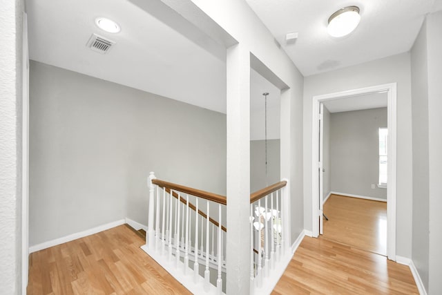 9410 Gatmere Ct, Sugar Land, TX 77498 - hall featuring an upstairs landing and wood finished floors