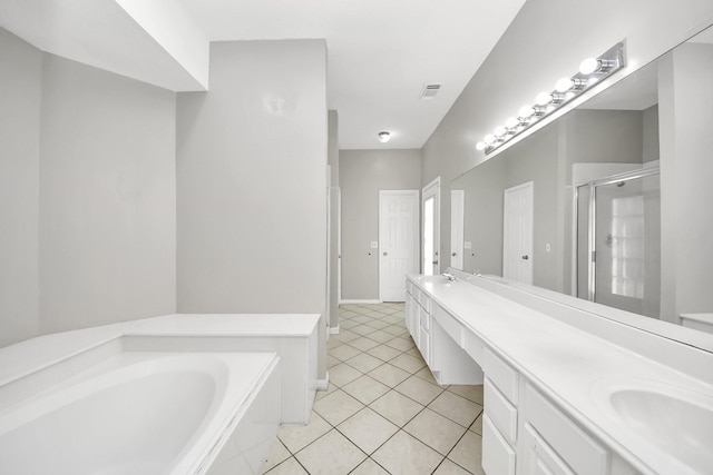 9410 Gatmere Ct, Sugar Land, TX 77498 - full bath featuring a stall shower, double vanity, a garden tub, and tile patterned flooring
