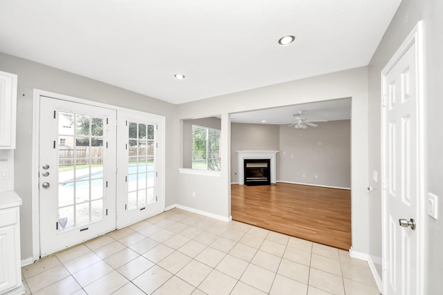 9410 Gatmere Ct, Sugar Land, TX 77498 - doorway featuring a ceiling fan, recessed lighting, light tile patterned flooring, and a fireplace with flush hearth