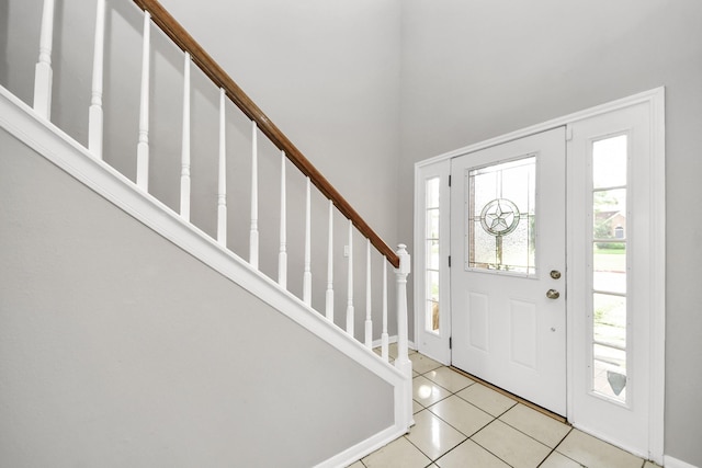 9410 Gatmere Ct, Sugar Land, TX 77498 - entryway featuring light tile patterned flooring and stairway