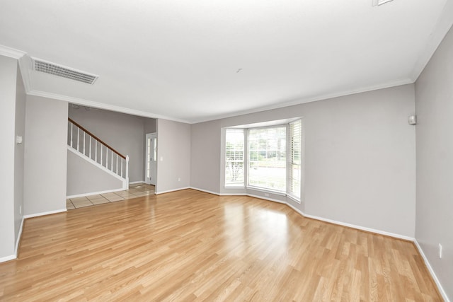 9410 Gatmere Ct, Sugar Land, TX 77498 - spare room featuring light wood-style flooring, ornamental molding, and stairs