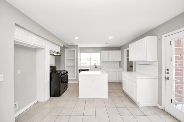 9410 Gatmere Ct, Sugar Land, TX 77498 - kitchen featuring black gas range oven, under cabinet range hood, light countertops, white cabinets, and recessed lighting