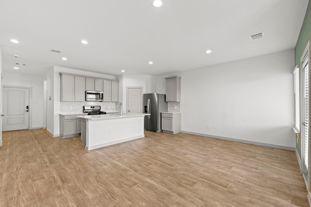 207 William Ln, Rosharon, TX 77583 - kitchen featuring stainless steel appliances, gray cabinetry, tasteful backsplash, recessed lighting, and light countertops