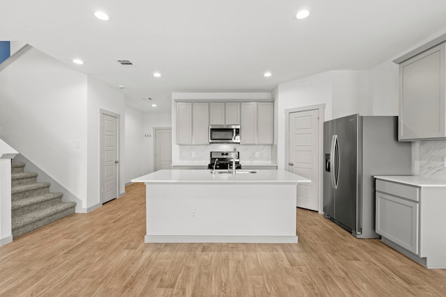 207 William Ln, Rosharon, TX 77583 - kitchen featuring gray cabinets, appliances with stainless steel finishes, decorative backsplash, and recessed lighting