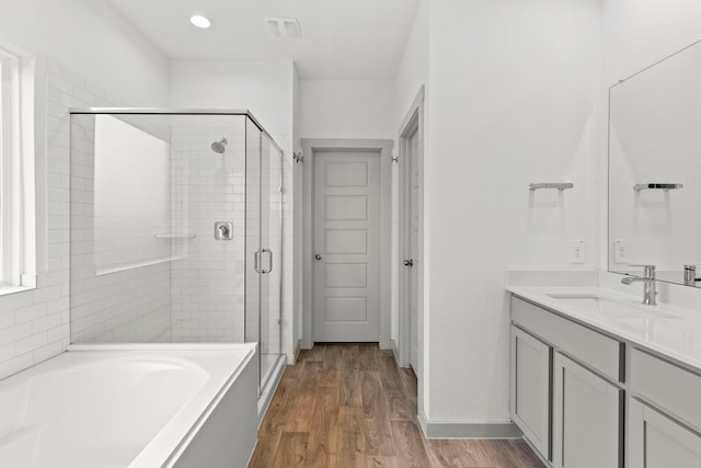 207 William Ln, Rosharon, TX 77583 - full bathroom featuring vanity, a shower stall, a garden tub, and wood finished floors