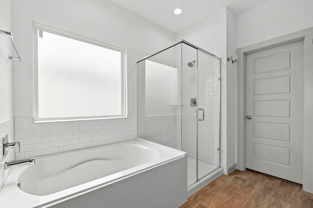 207 William Ln, Rosharon, TX 77583 - bathroom featuring a bath, a stall shower, and wood finished floors