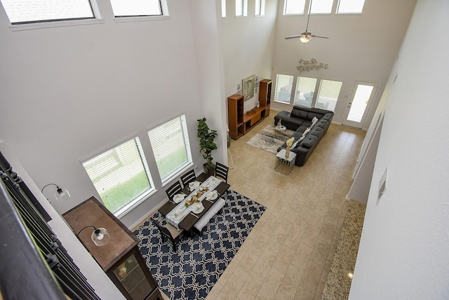 4615 Montcliff Bend Ln, Sugar Land, TX 77479 - living room with a high ceiling, healthy amount of natural light, and a ceiling fan