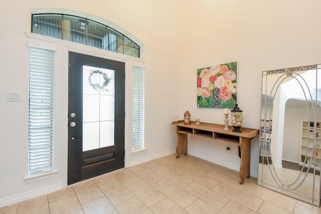4615 Montcliff Bend Ln, Sugar Land, TX 77479 - entrance foyer with healthy amount of natural light, arched walkways, and light tile patterned floors
