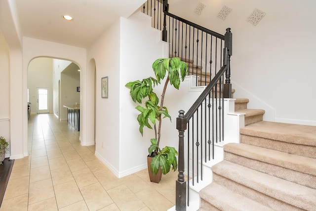 4615 Montcliff Bend Ln, Sugar Land, TX 77479 - staircase featuring arched walkways, tile patterned floors, and recessed lighting