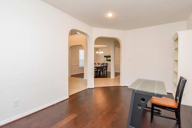 4615 Montcliff Bend Ln, Sugar Land, TX 77479 - home office featuring arched walkways, wood finished floors, a chandelier, and recessed lighting