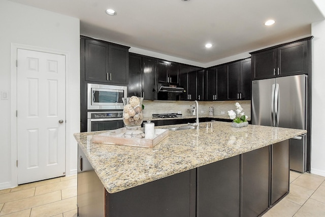 4615 Montcliff Bend Ln, Sugar Land, TX 77479 - kitchen featuring stainless steel appliances, light tile patterned flooring, dark cabinets, and recessed lighting