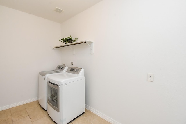 4615 Montcliff Bend Ln, Sugar Land, TX 77479 - laundry room with washing machine and dryer and light tile patterned floors