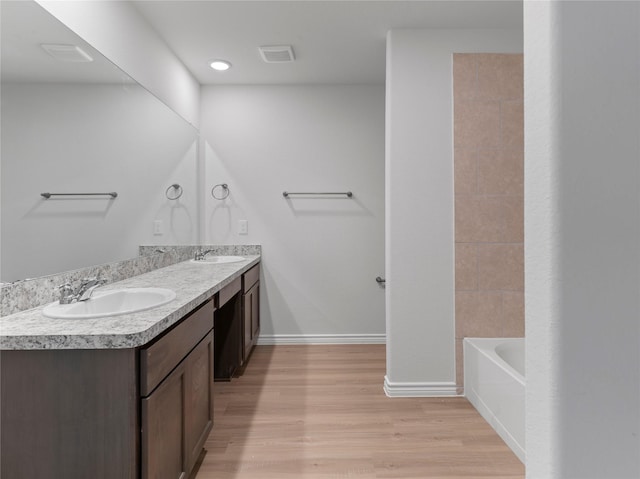 312 N Orange St, Sweeny, TX 77480 - full bathroom with double vanity and wood finished floors