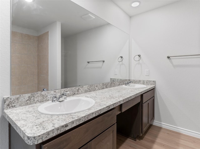 312 N Orange St, Sweeny, TX 77480 - full bathroom featuring wood finished floors and double vanity