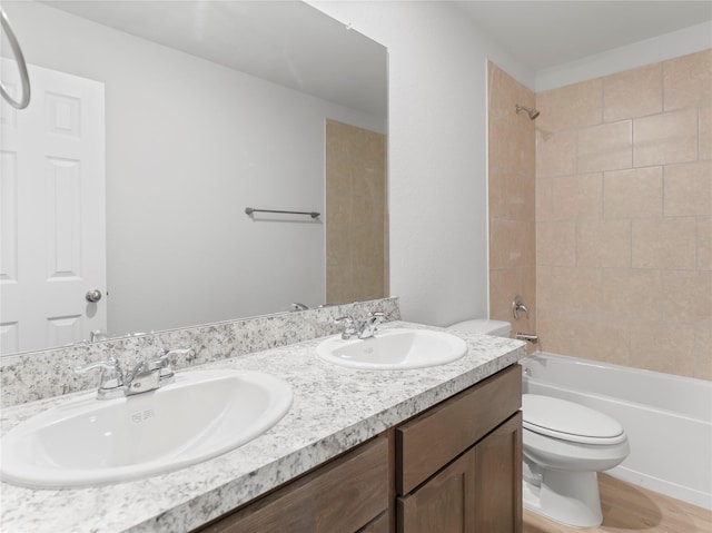 312 N Orange St, Sweeny, TX 77480 - bathroom with double vanity, tub / shower combination, and wood finished floors