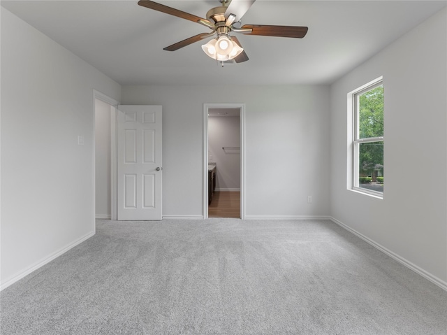 312 N Orange St, Sweeny, TX 77480 - unfurnished bedroom with carpet flooring, ensuite bathroom, and ceiling fan