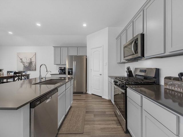 17831 Sommerset Falls Ln, Crosby, TX 77532 - kitchen featuring appliances with stainless steel finishes, dark countertops, dark wood-style flooring, recessed lighting, and gray cabinets
