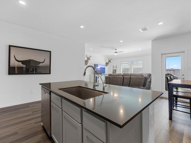 17831 Sommerset Falls Ln, Crosby, TX 77532 - kitchen featuring dishwasher, dark countertops, dark wood-style floors, a ceiling fan, and recessed lighting