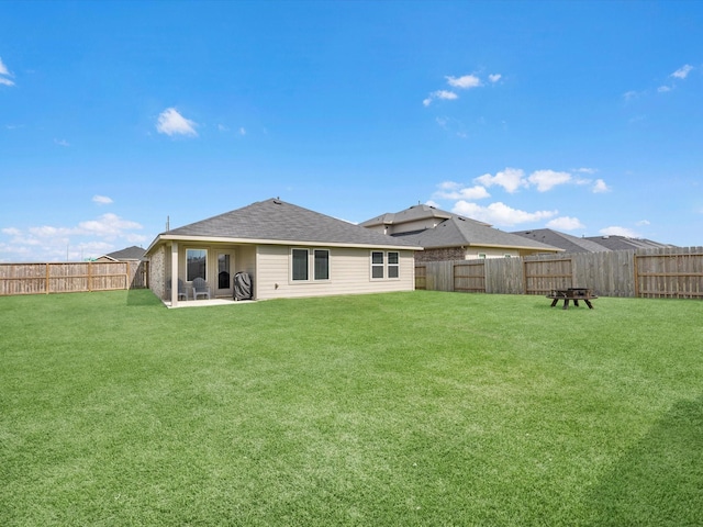 17831 Sommerset Falls Ln, Crosby, TX 77532 - back of property with a fenced backyard, a shingled roof, and a patio