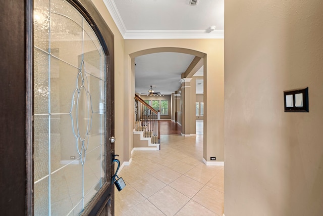 15015 Cozy Hollow Ln, Houston, TX 77044 - foyer entrance featuring arched walkways, crown molding, light tile patterned floors, ceiling fan, and stairway