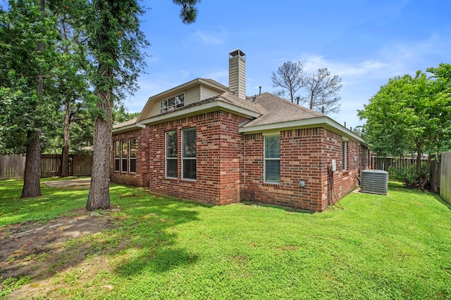 15015 Cozy Hollow Ln, Houston, TX 77044 - rear view of property with brick siding, a fenced backyard, a chimney, and roof with shingles