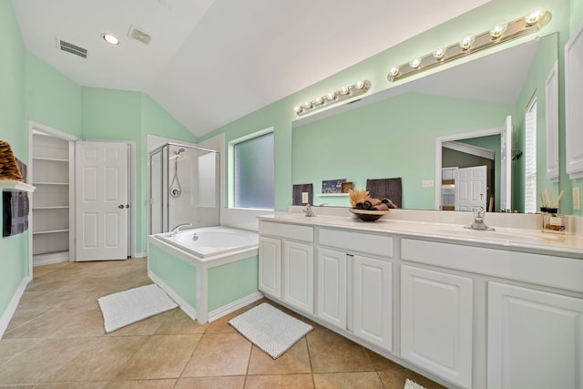 15015 Cozy Hollow Ln, Houston, TX 77044 - full bathroom with a shower stall, lofted ceiling, double vanity, a garden tub, and tile patterned flooring