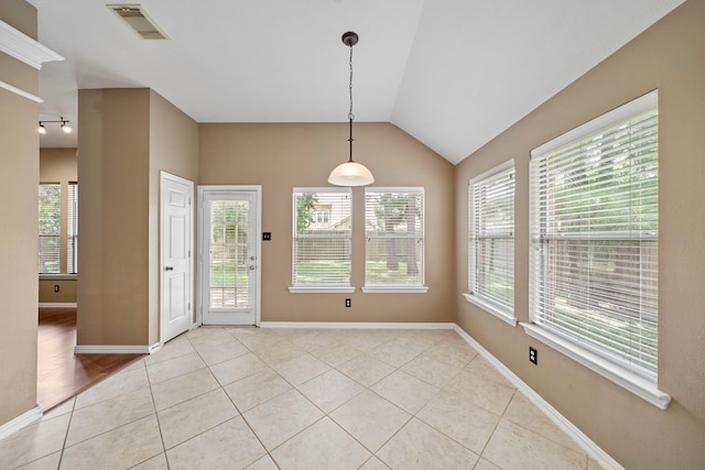 15015 Cozy Hollow Ln, Houston, TX 77044 - unfurnished dining area featuring healthy amount of natural light, light tile patterned floors, and lofted ceiling