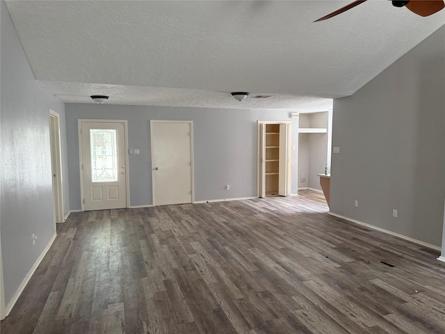 4706 Owens Creek Ln, Spring, TX 77388 - unfurnished living room featuring a textured ceiling, dark wood-style flooring, and ceiling fan