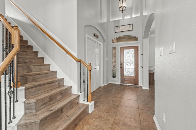 14402 Hazeldale Dr, Cypress, TX 77429 - foyer entrance featuring arched walkways, stairs, and a high ceiling