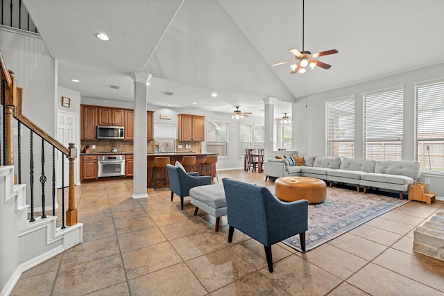 14402 Hazeldale Dr, Cypress, TX 77429 - living area featuring a ceiling fan, ornate columns, recessed lighting, stairs, and high vaulted ceiling