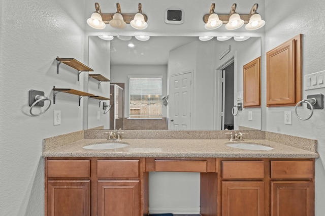 14402 Hazeldale Dr, Cypress, TX 77429 - full bath with double vanity, a textured wall, and a shower