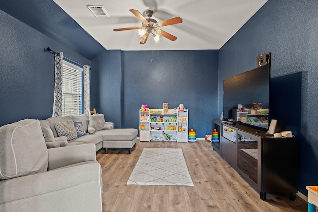 14402 Hazeldale Dr, Cypress, TX 77429 - living room featuring a textured wall, ceiling fan, wood finished floors, and lofted ceiling