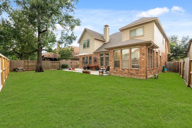 14402 Hazeldale Dr, Cypress, TX 77429 - back of house featuring brick siding, roof with shingles, a patio area, a chimney, and a fenced backyard